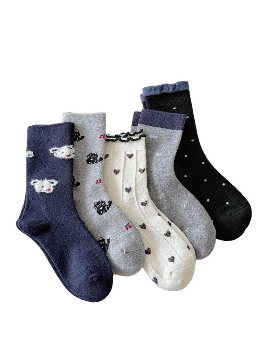 Navy, gray, cream and black patterned socks arranged on a white background.