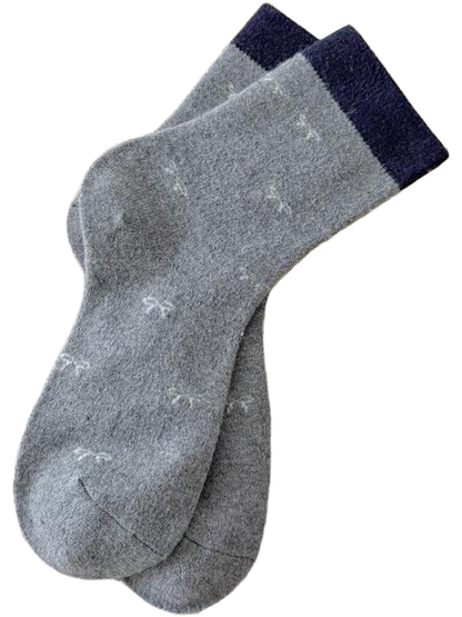 Gray Bows socks with small white bow motifs and contrasting navy cuffs.