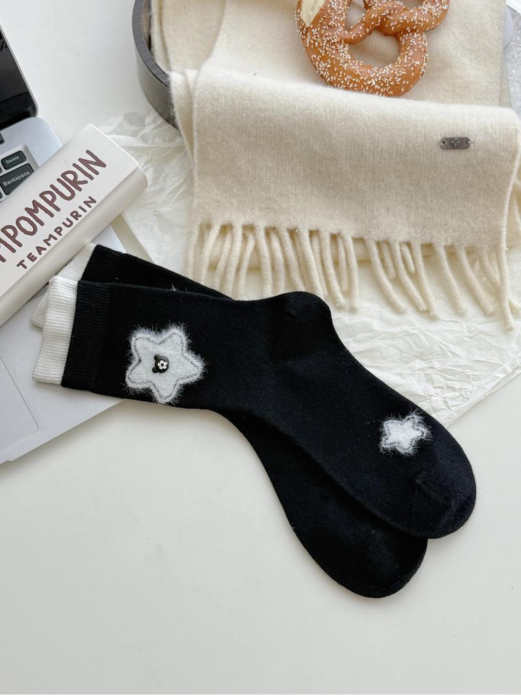 Flowers style black socks with fuzzy white flower motifs and contrasting white cuff edges.