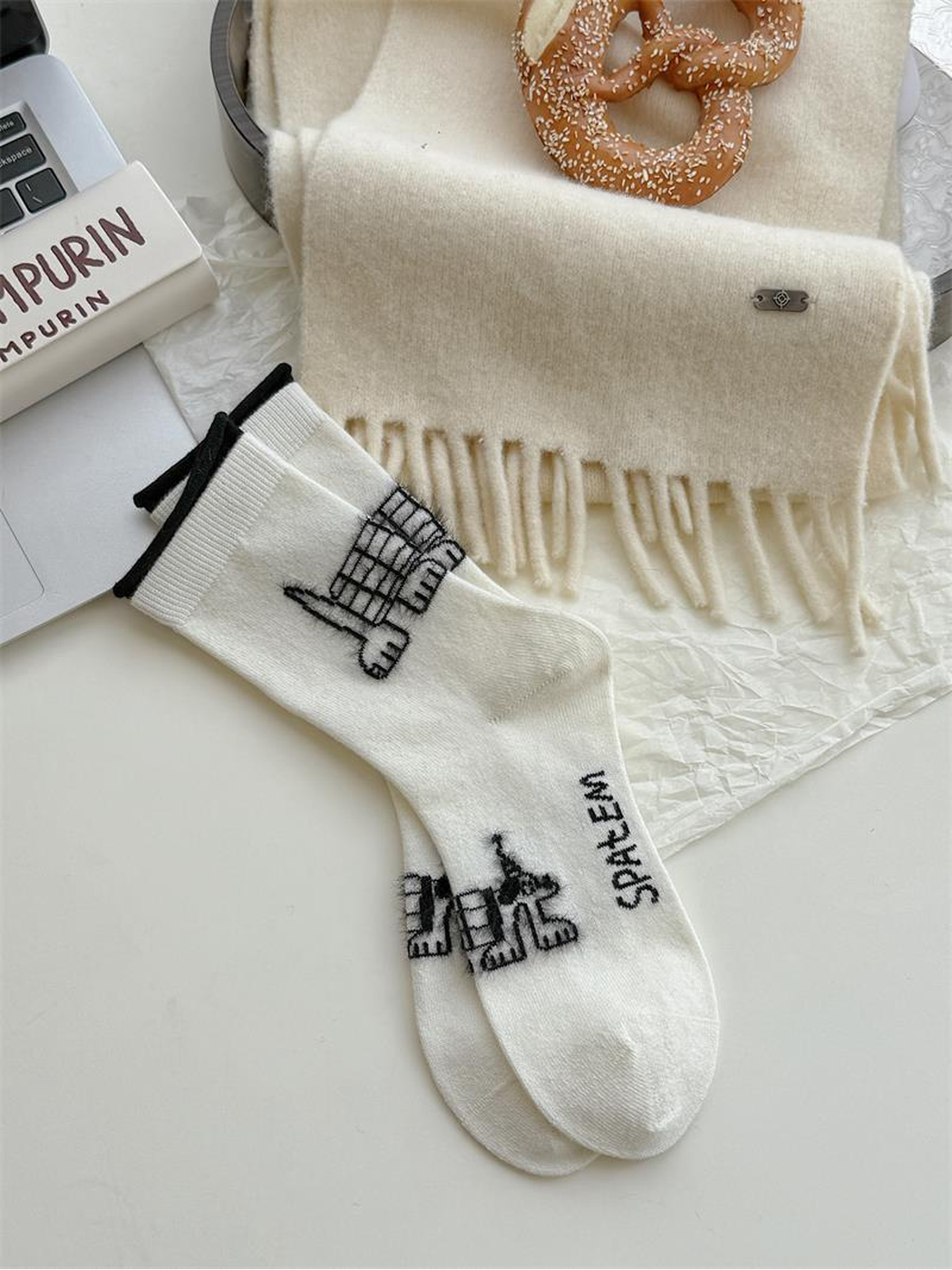 Dogs style ivory socks with black outlined dog motifs and black cuff edges.