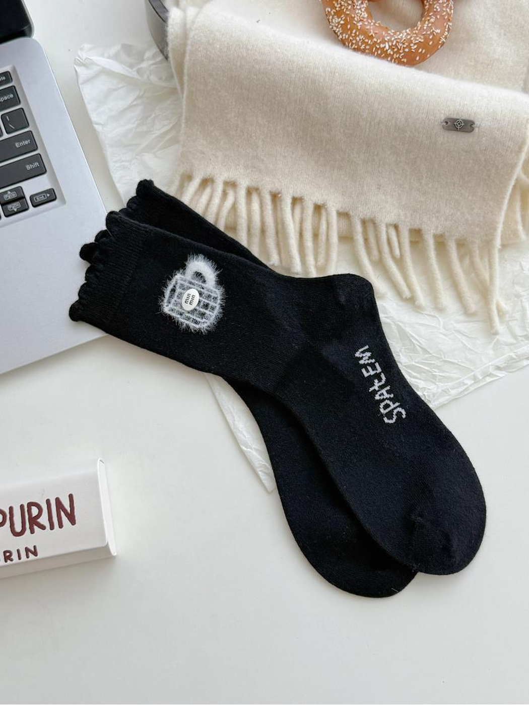 Teacups style black socks with fuzzy white teacup motifs, contrasting lettering and scalloped cuffs.