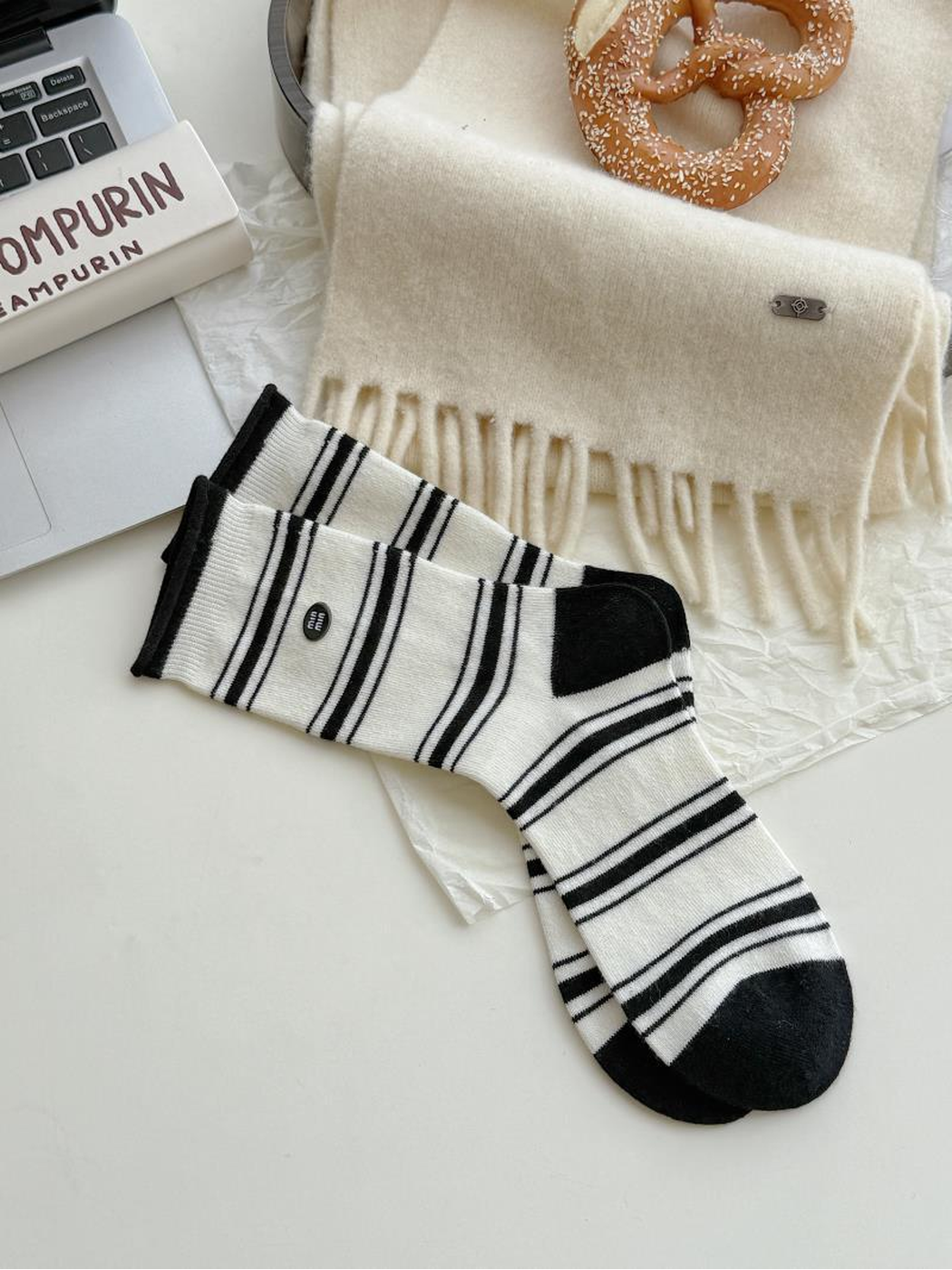 Stripes style ivory socks with black stripes, contrasting black heels and toes, and small oval labels.