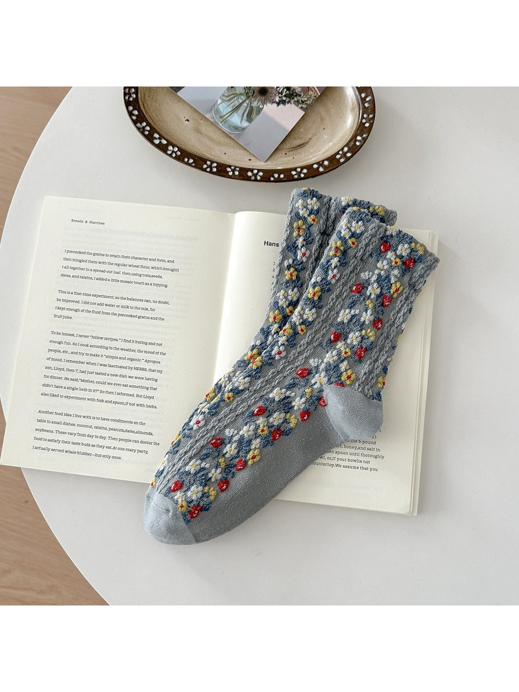 Gray floral socks with red, yellow and white flowers, textured vertical bands, and plain toe and heel panels.