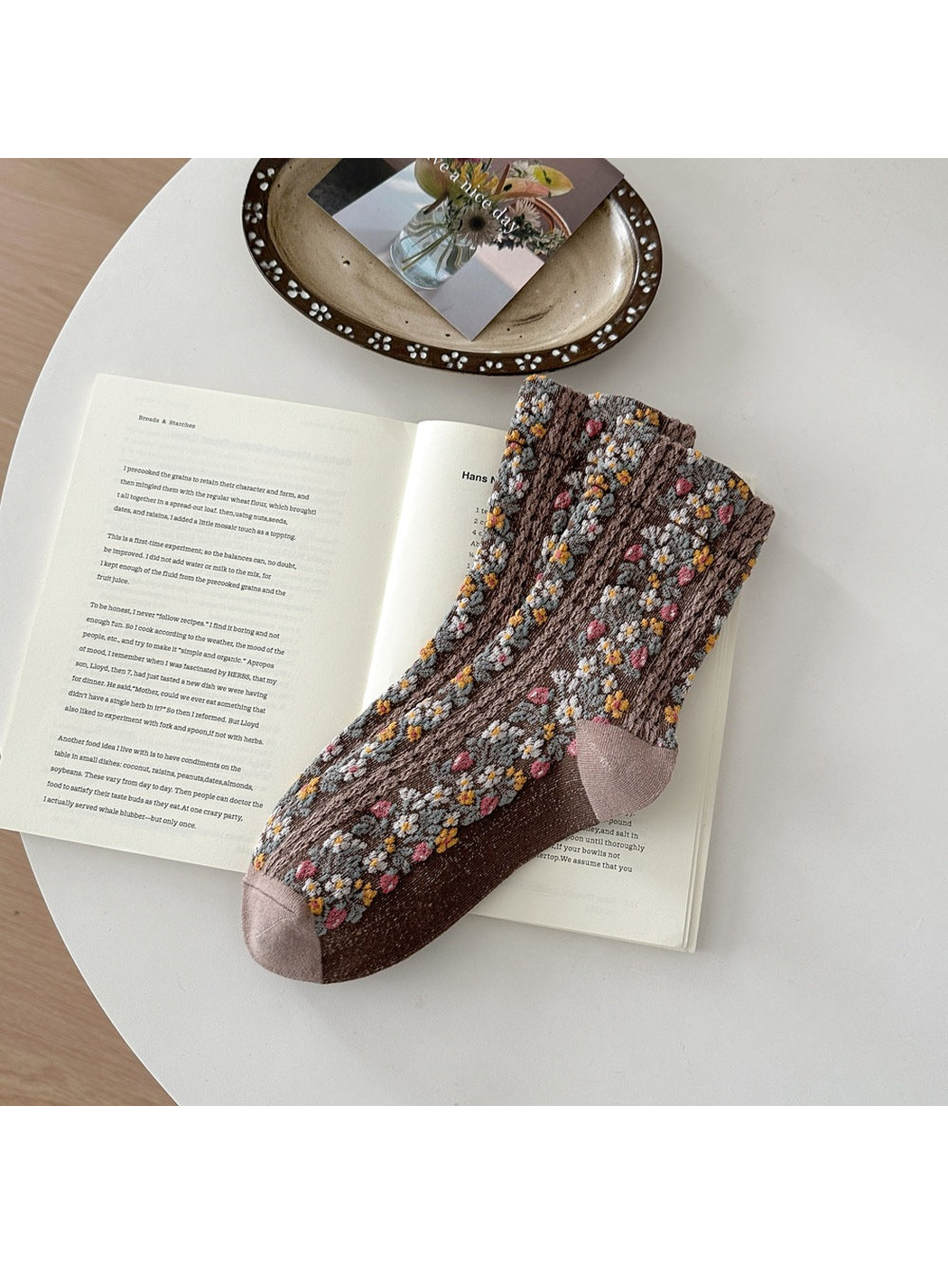 Brown floral socks with pink, yellow and white flowers and taupe toe and heel panels.