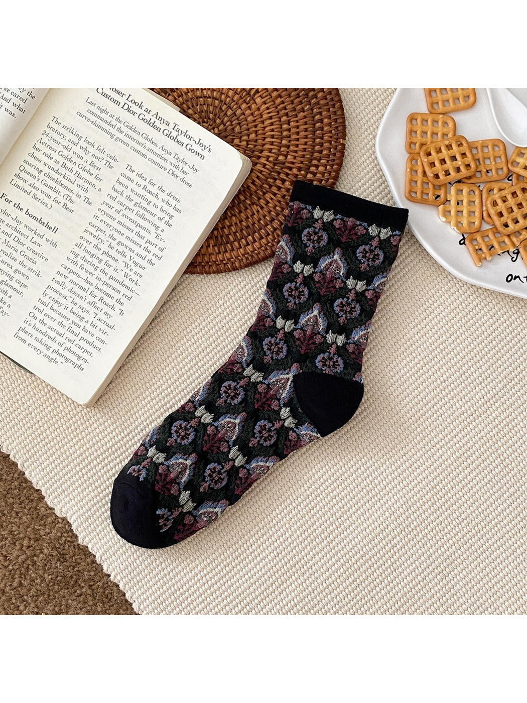 Black floral sock with a ribbed cuff and contrasting heel and toe panels.