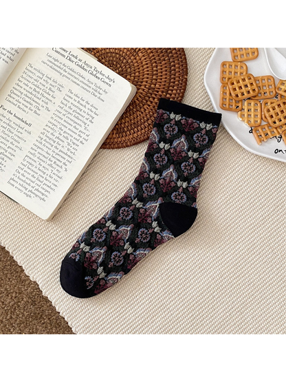 Black floral sock with a ribbed cuff and contrasting heel and toe panels.