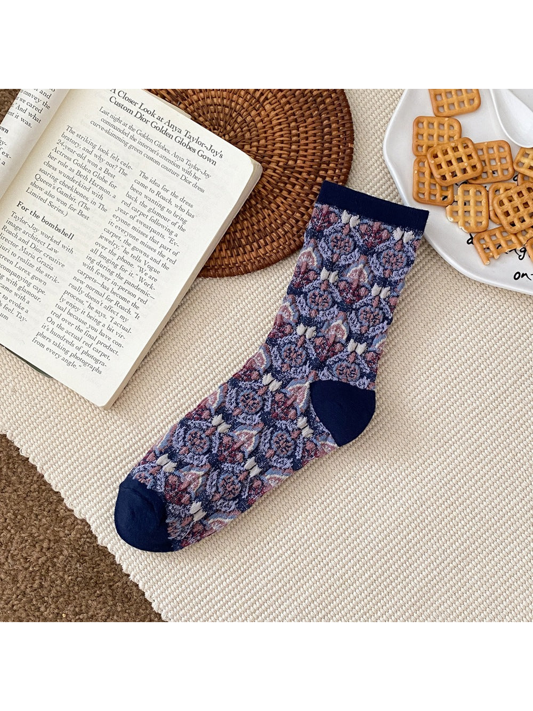 Navy floral sock with a ribbed cuff and contrasting heel and toe panels.
