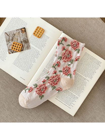 Ivory sock with raised red flowers, green leaves and plain toe and heel sections.