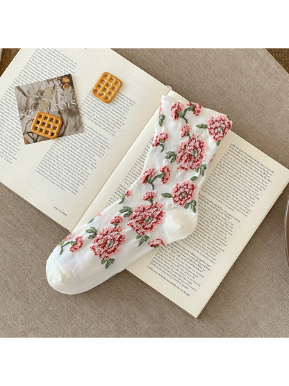 White sock with raised red flowers, green leaves and plain toe and heel sections.