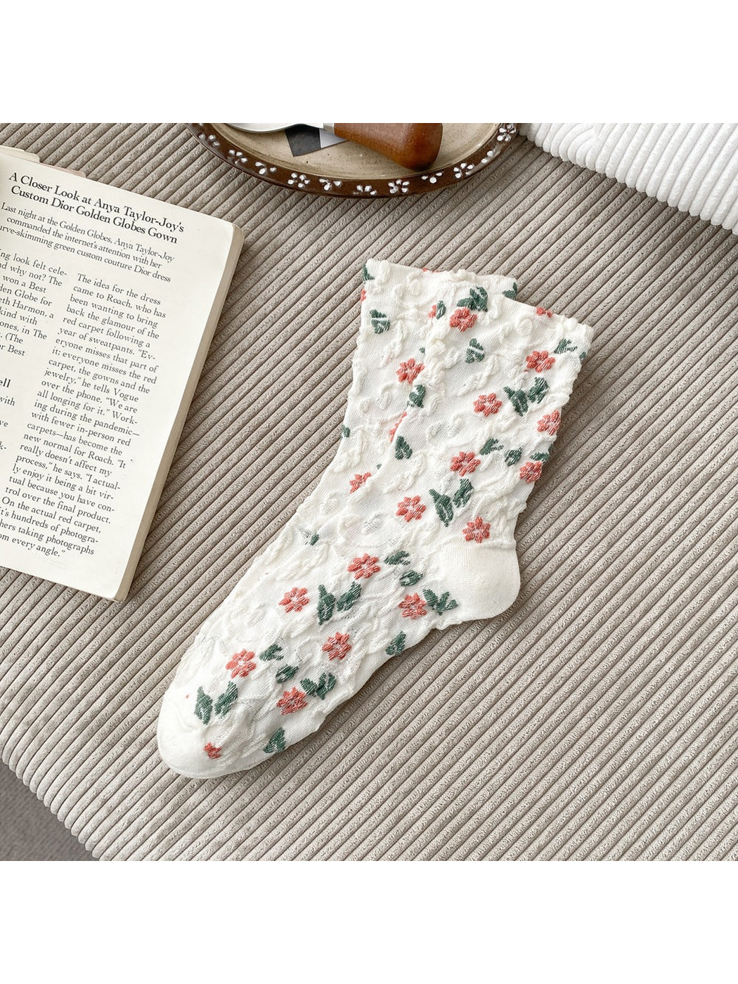 White socks with coral flowers, green leaves and scalloped cuffs.