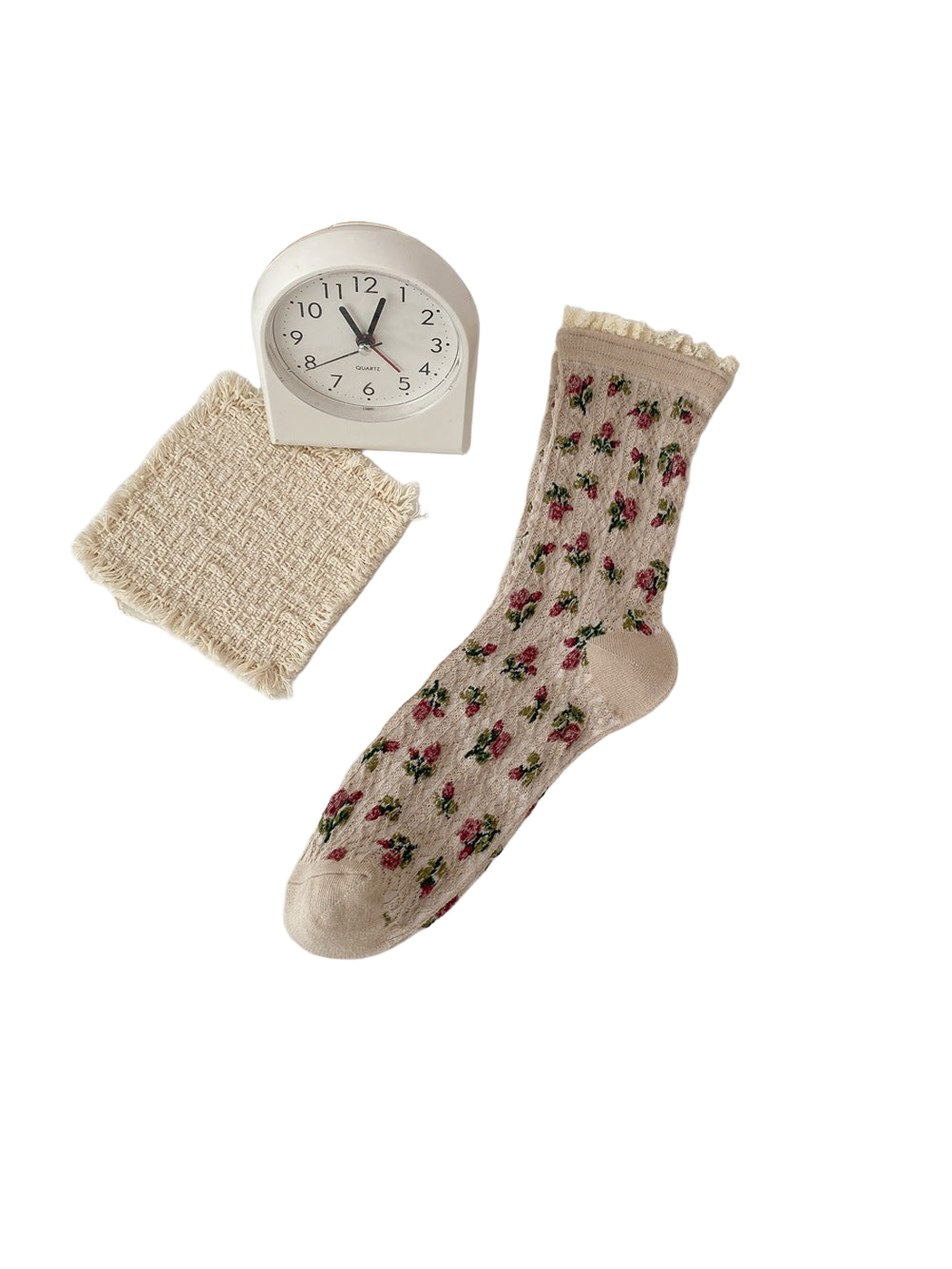 Beige sock with burgundy flowers, green leaves and a cream ruffled cuff.