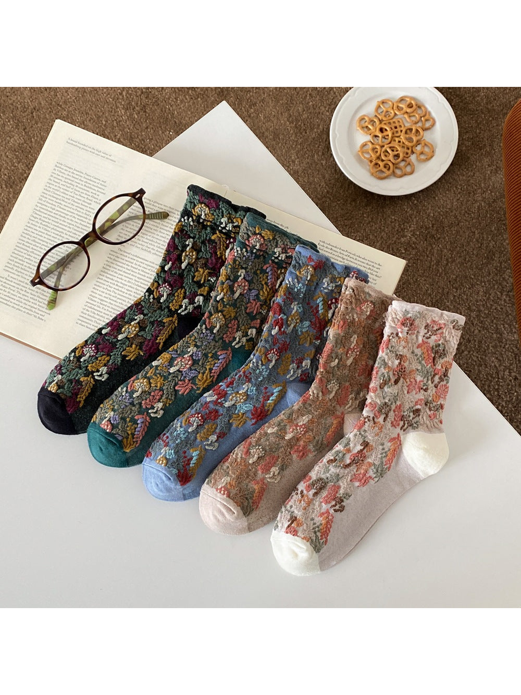 Mushroom and foliage crew socks displayed in Black, Deep Teal, Blue, Khaki and Beige.