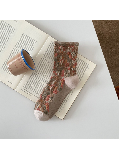 Khaki sock with raised mushroom and foliage motifs and a ribbed cuff.