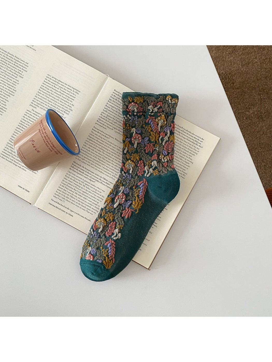 Deep Teal sock with raised mushroom and foliage motifs and a ribbed cuff.