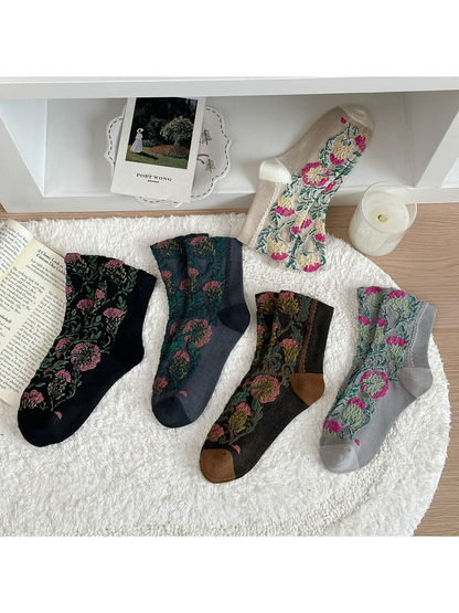 Floral socks in five colors arranged flat with their heels and toes visible.