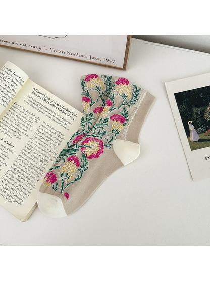 Beige floral sock laid flat with cream heel and toe panels.