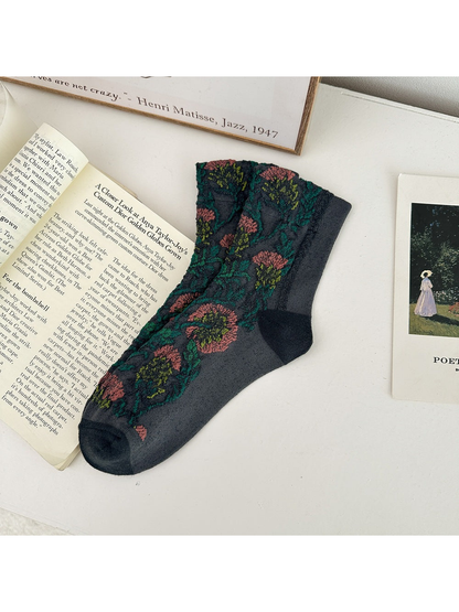 Dark Gray floral sock laid flat with darker heel and toe panels.