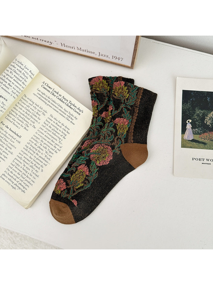 Brown floral sock laid flat with brown heel and toe panels.