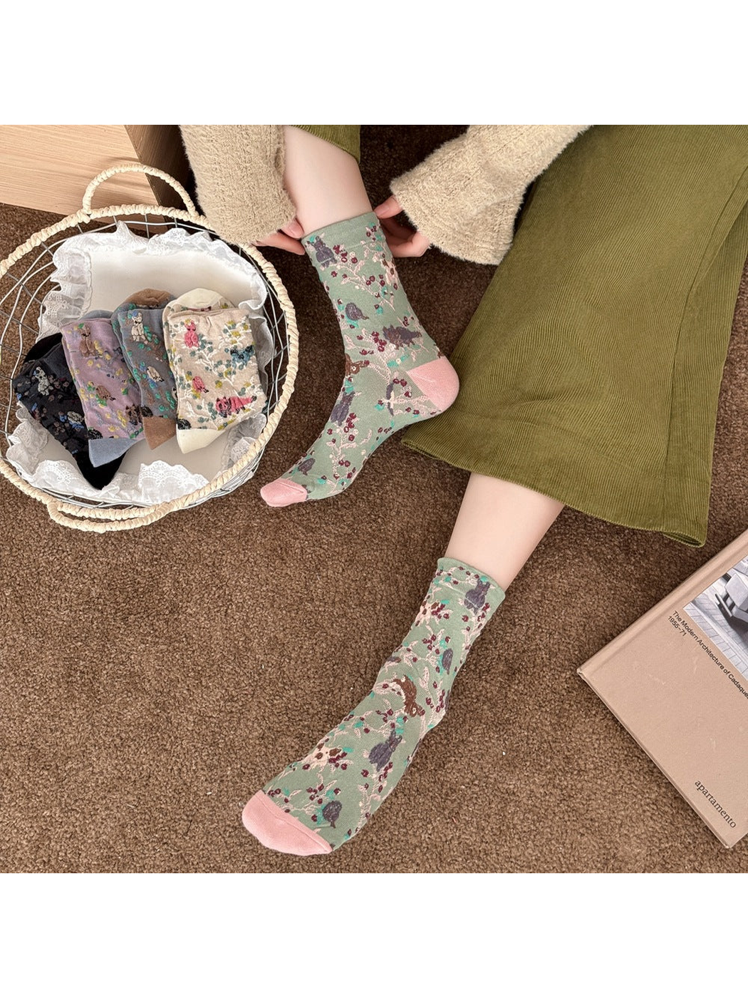 Green patterned socks worn beside a basket of other colors.