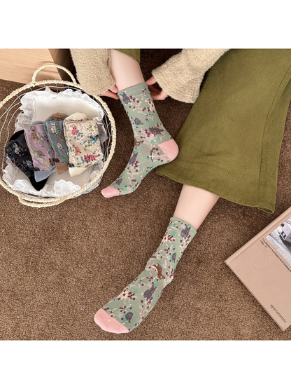 Green patterned socks worn beside a basket of other colors.