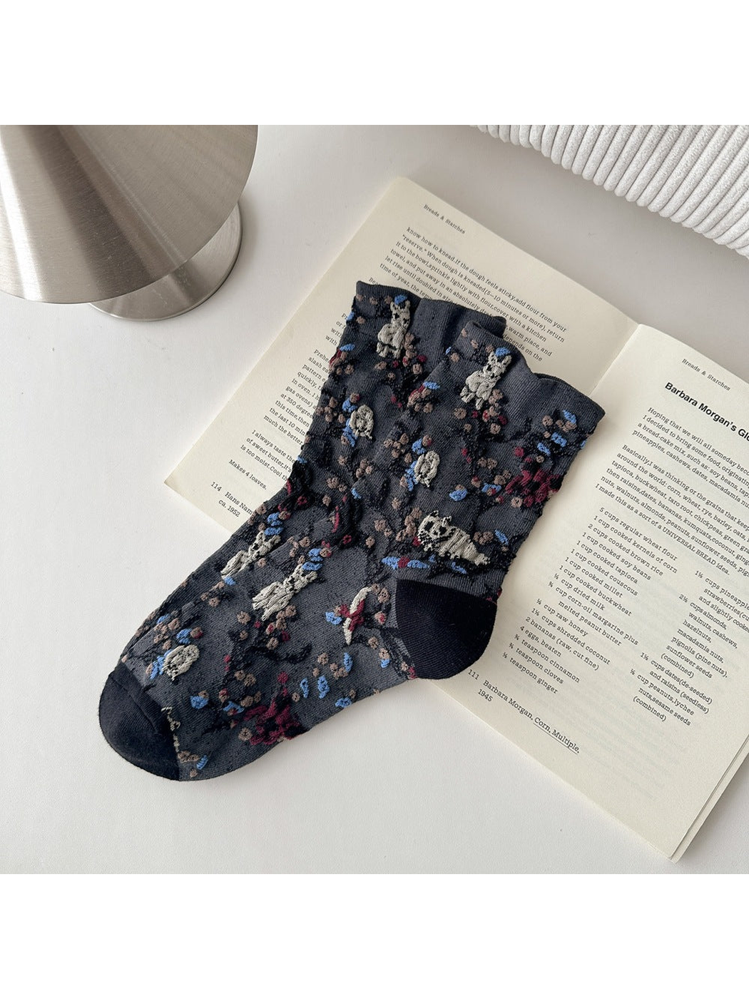 Dark Gray socks with animal and botanical patterns and contrasting toes and heels.