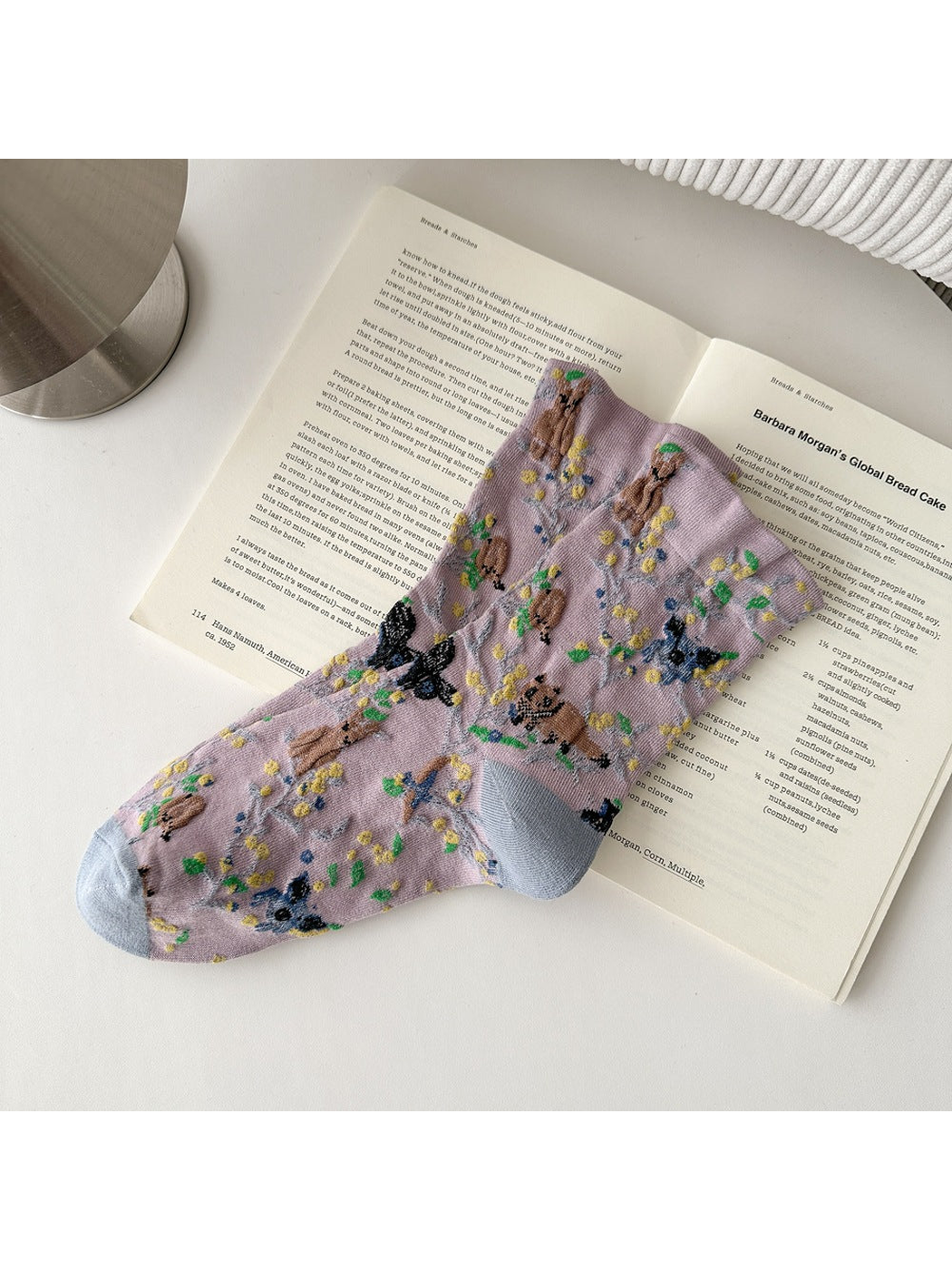 Purple socks with animal and botanical patterns and contrasting toes and heels.
