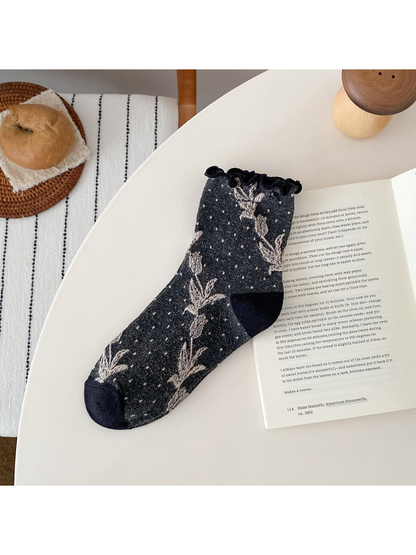 Dark Gray sock with floral vines, small dots, a ruffled cuff, and contrasting heel and toe panels.