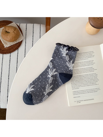 Blue Gray sock with floral vines, small dots, a ruffled cuff, and contrasting heel and toe panels.
