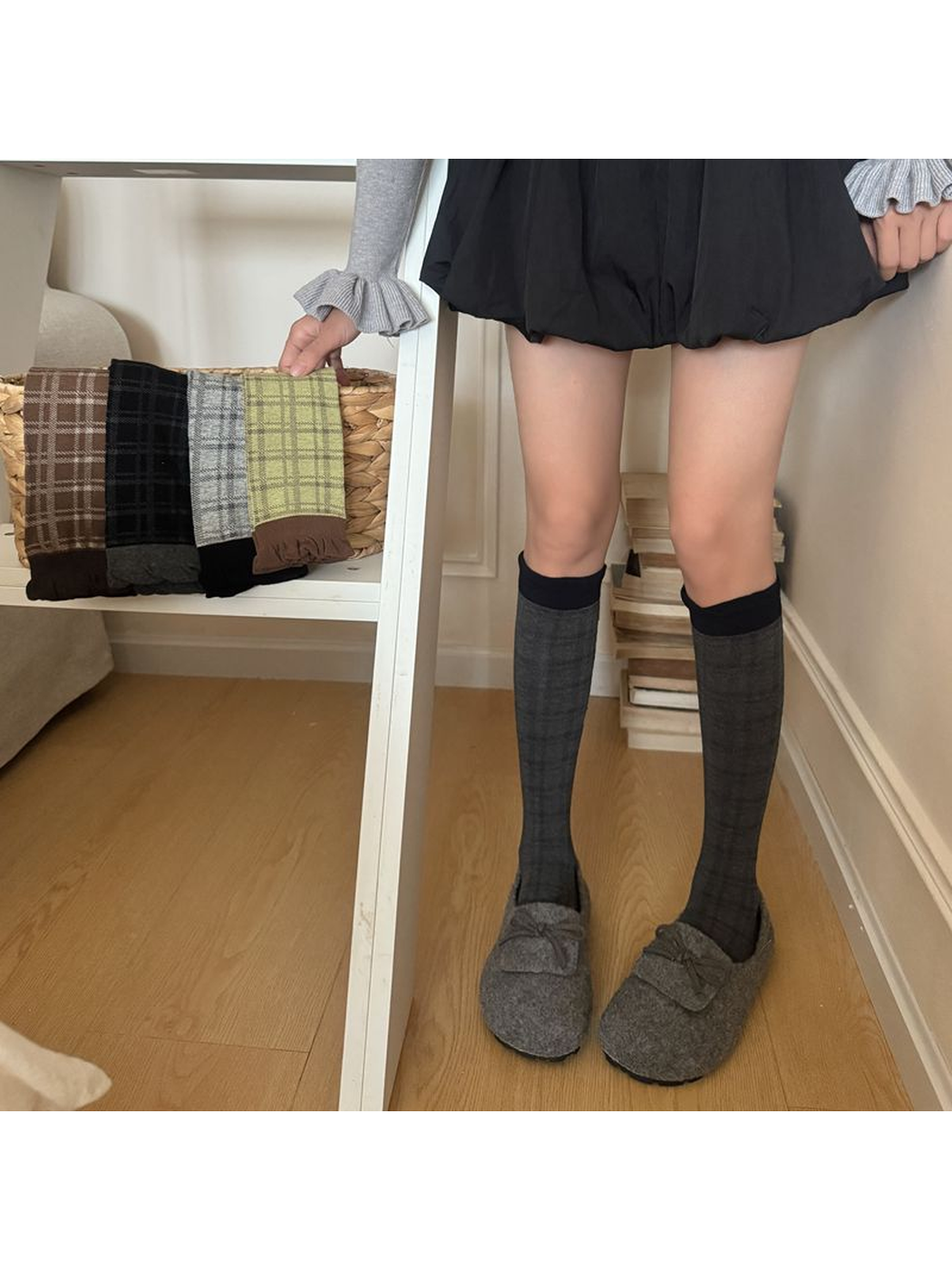 Dark Gray plaid socks worn with gray shoes, with other sock colors displayed nearby.