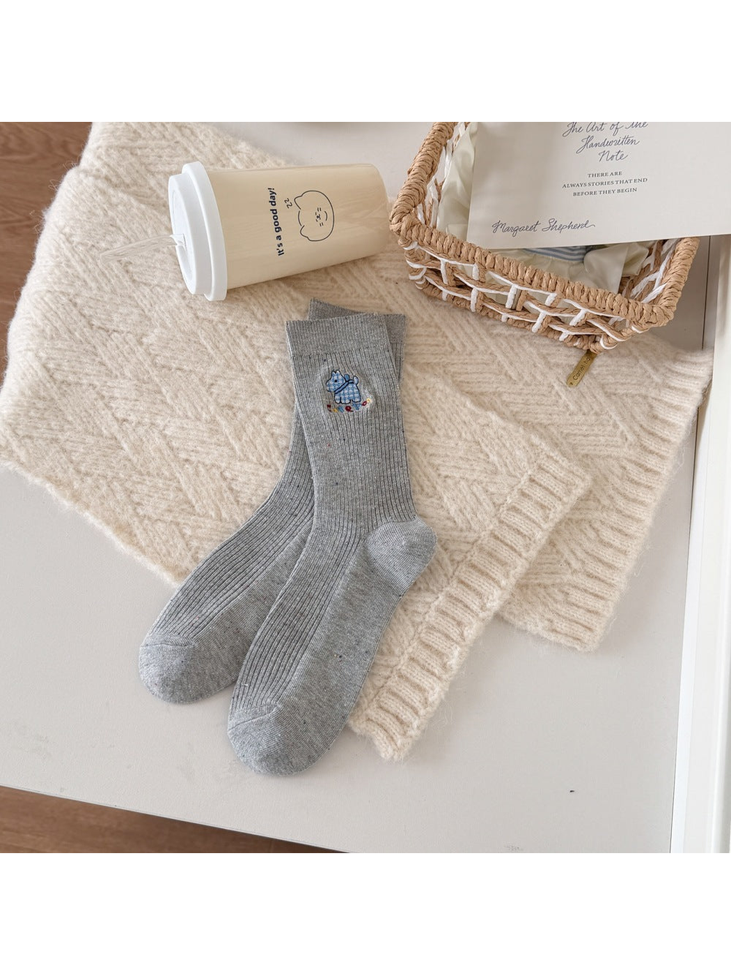 Light Gray ribbed socks with a blue checked dog motif, multicolored lettering and flecks.