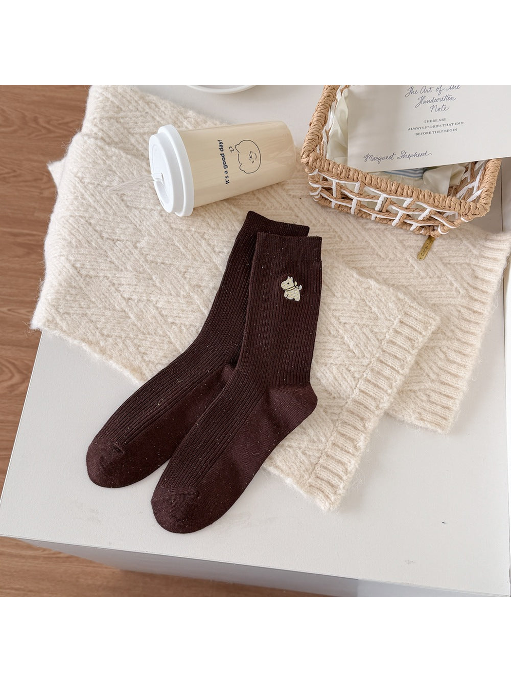 Brown ribbed socks with a yellow checked dog motif and multicolored flecks.