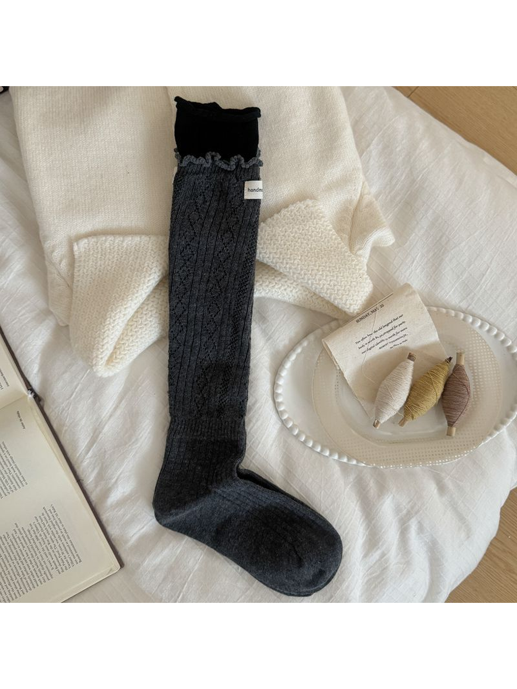 Dark Gray sock with diamond pointelle, vertical ribbing, a ruffled edge and contrasting black cuff.