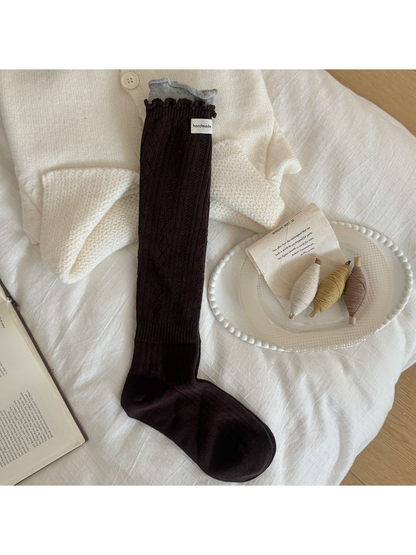 Dark Brown sock with diamond pointelle, vertical ribbing, a ruffled edge and contrasting light gray cuff.