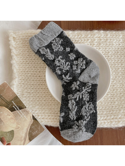 Black Gray floral sock with gray flowers and a contrasting gray cuff, heel and toe.