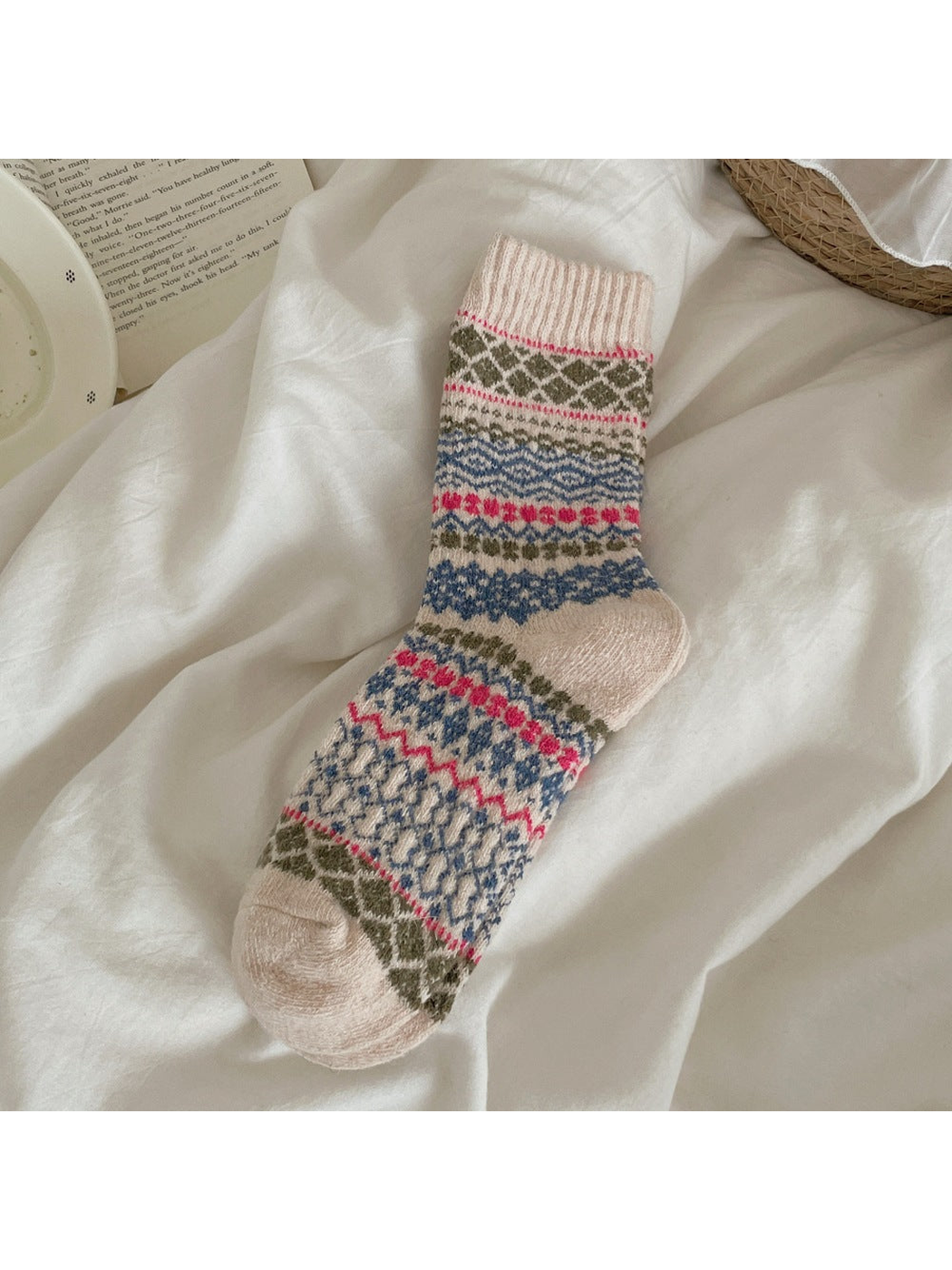 Beige sock with multicolored diamond and zigzag bands and a ribbed cuff.