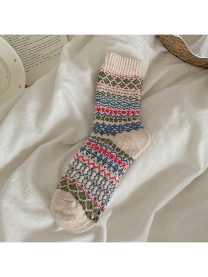 Beige sock with multicolored diamond and zigzag bands and a ribbed cuff.