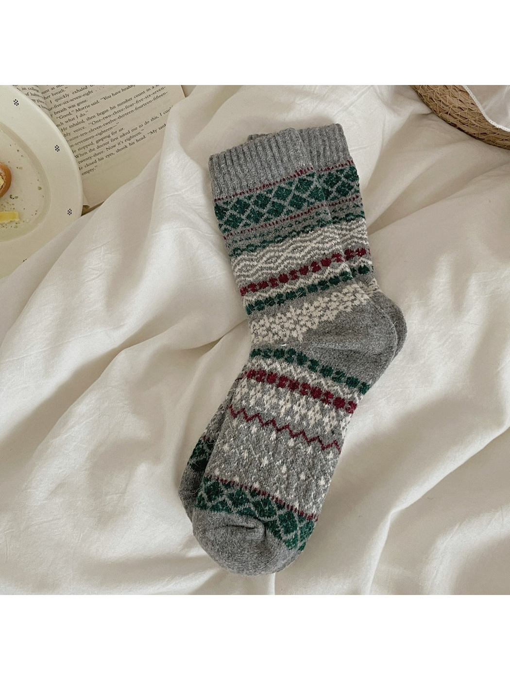 Gray sock with green, red, and ivory geometric bands and a ribbed cuff.