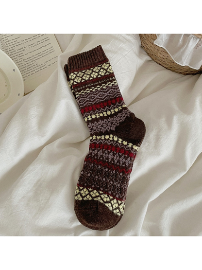 Brown sock with contrasting diamond and zigzag bands and a ribbed cuff.