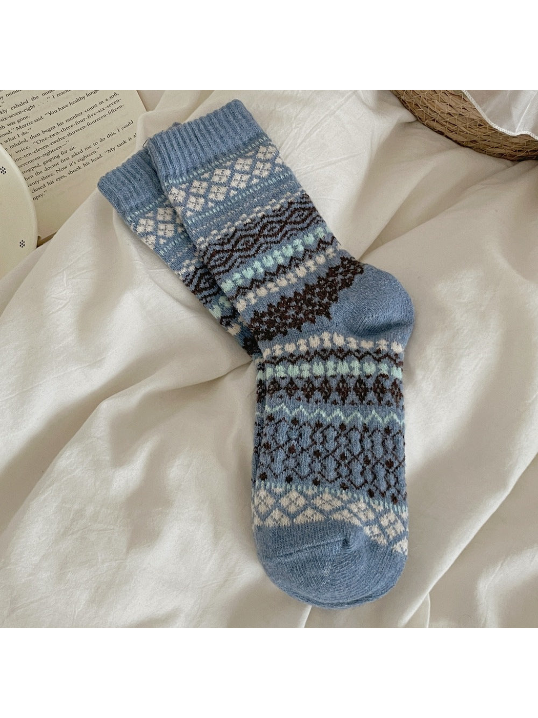 Blue socks with contrasting diamond and zigzag bands and ribbed cuffs.