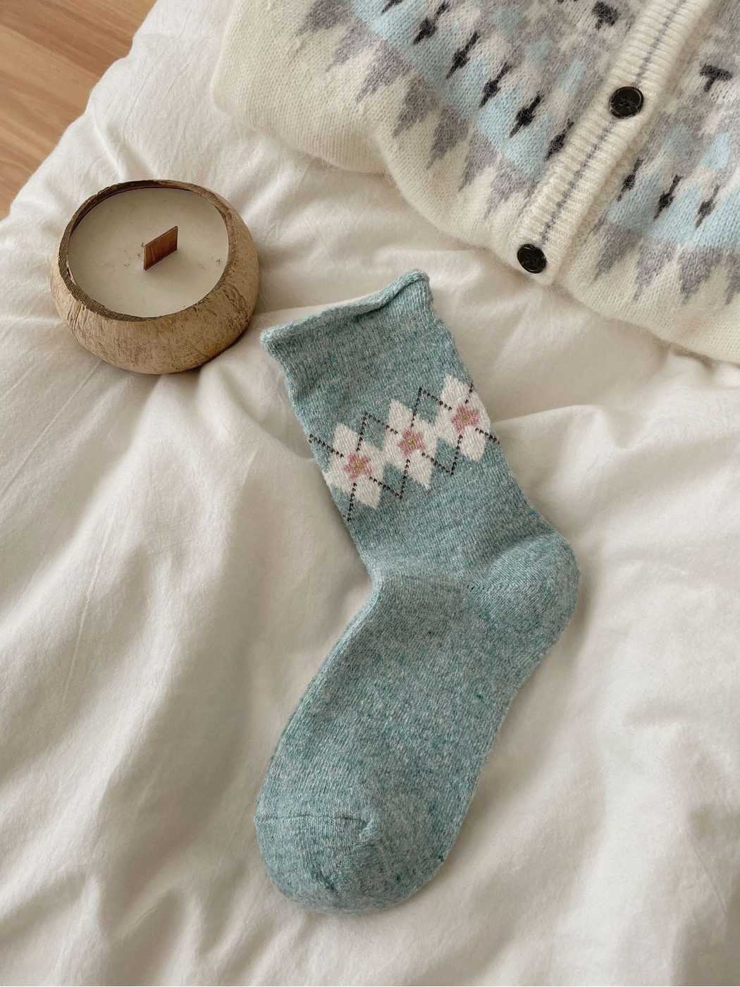 Mint sock with ivory flowers, pink centers, dotted diamonds, and a rolled cuff.