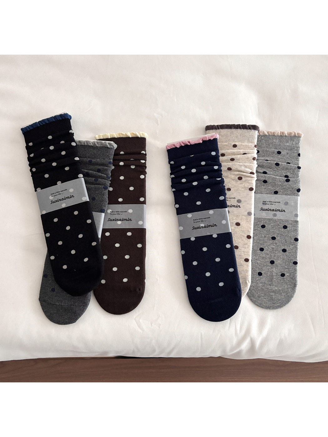 Polka dot socks in six colors with contrasting ruffled cuff edges.