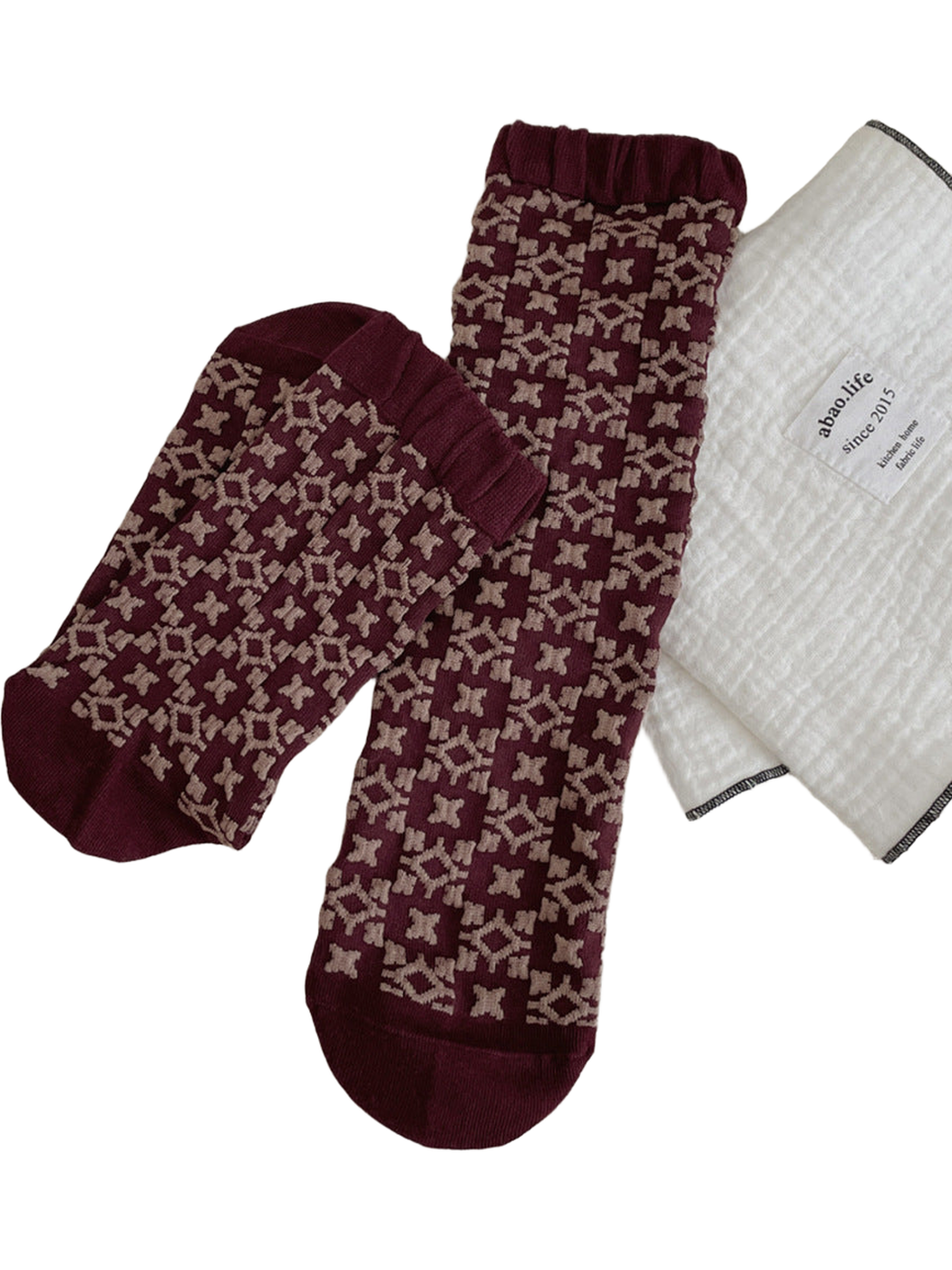 Burgundy Geometric socks with beige motifs and ribbed cuffs.
