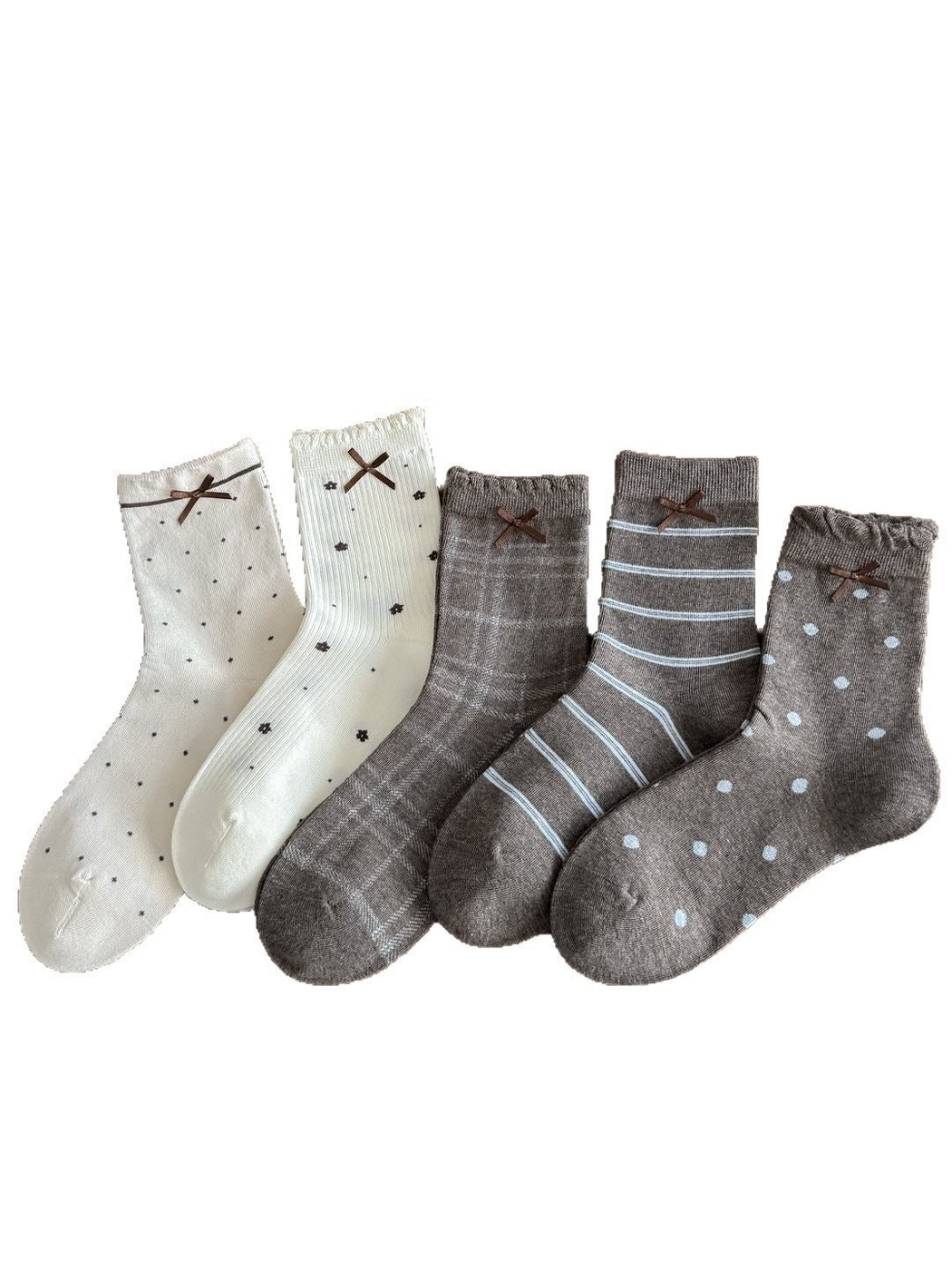 Ivory and gray socks with small dots, flowers, plaid, stripes and large dots, each with a brown ribbon bow.