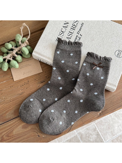 Gray Large Dots socks with blue dots, ruffled cuffs and a brown ribbon bow.
