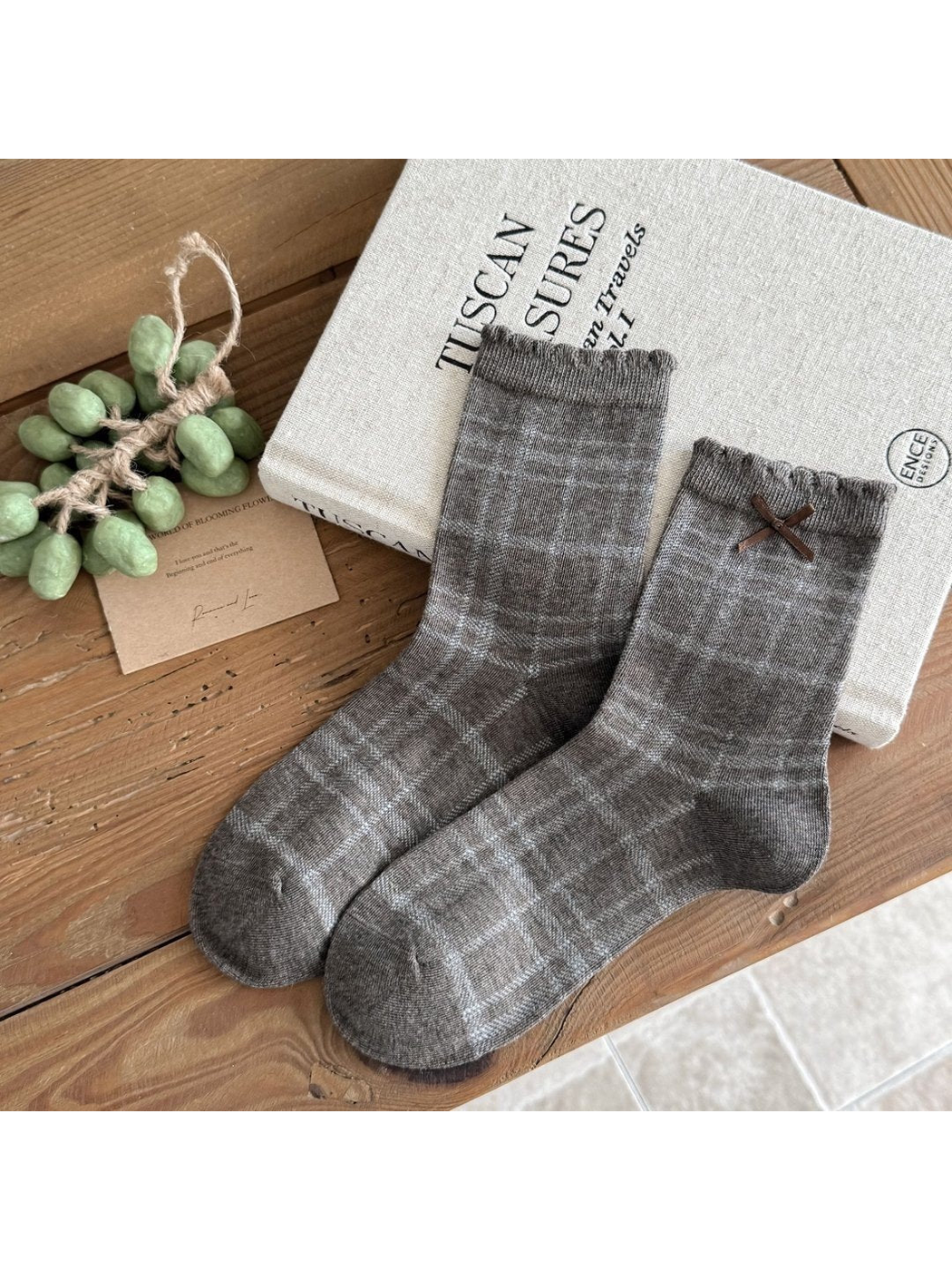 Heather gray Plaid socks with ruffled cuffs and a brown ribbon bow.