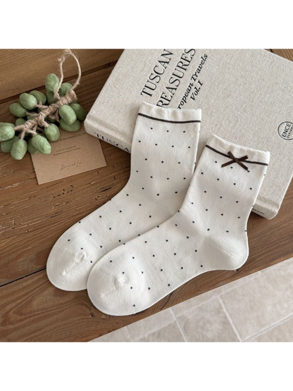 Ivory Small Dots socks with dark dots, a thin stripe below each cuff and a brown ribbon bow.