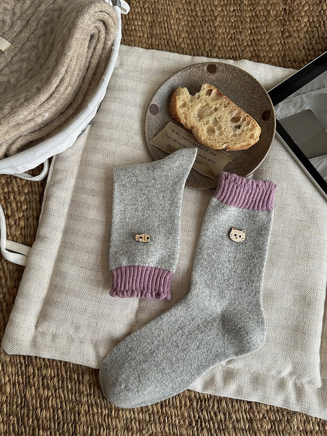 Purple color socks with light gray bodies, purple ribbed cuffs, and cat face and fish emblems.
