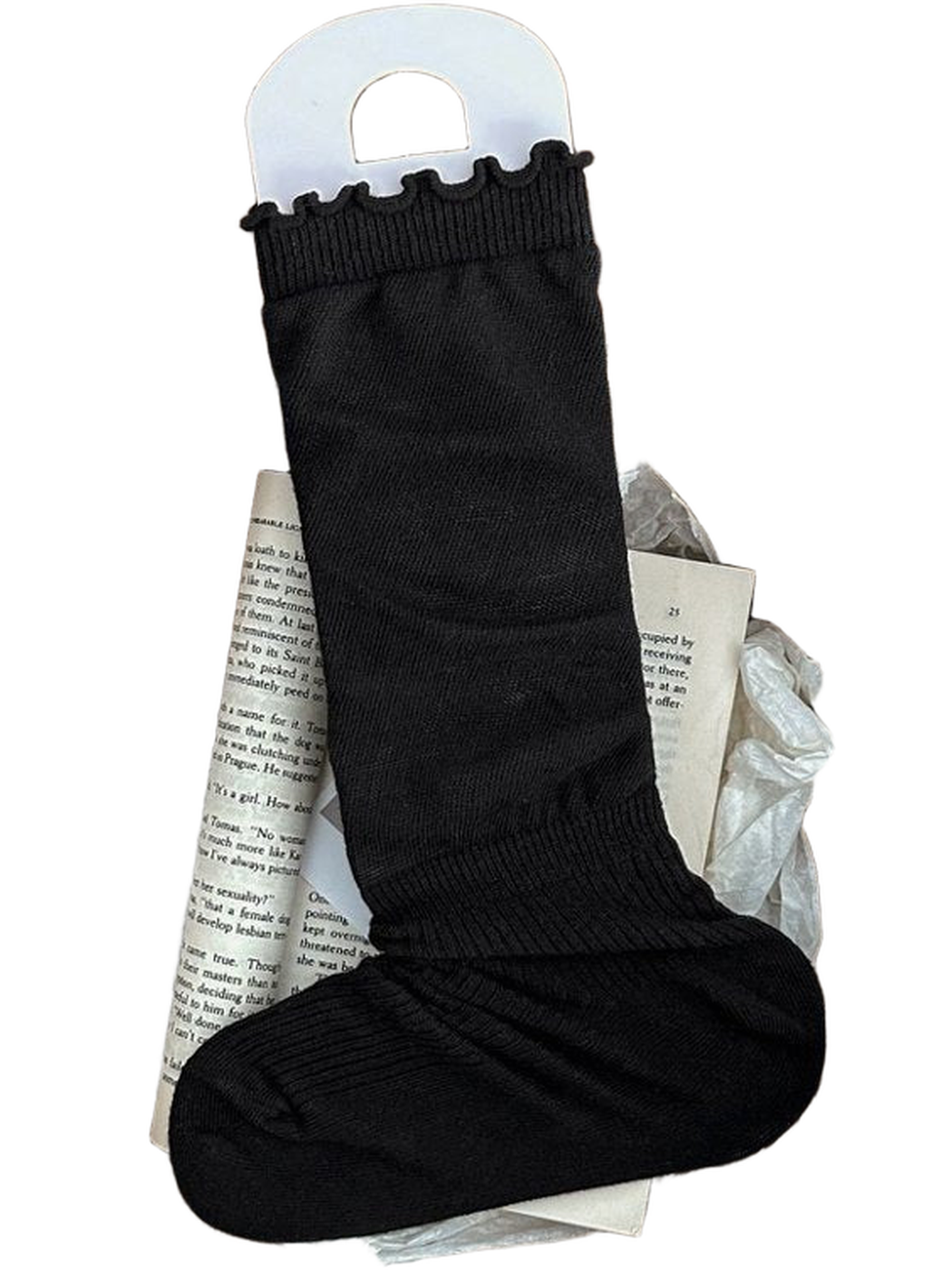 Black sock with a ruffled cuff and ribbed ankle and foot displayed in a woven basket.