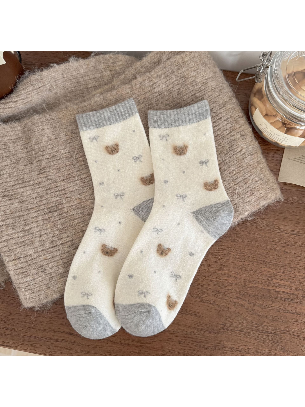 Ivory socks with gray cuffs, heels and toes, fuzzy bear heads, bows, dots and hearts.