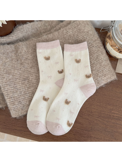 Ivory socks with pink cuffs, heels and toes, fuzzy bear heads, bows, dots and hearts.